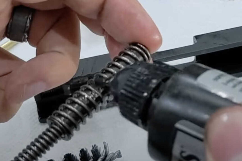 Apply a thin layer of oil to the Springfield XD recoil assembly spring